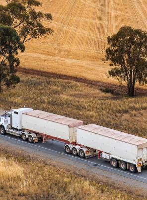 Truck driving past wheat fields