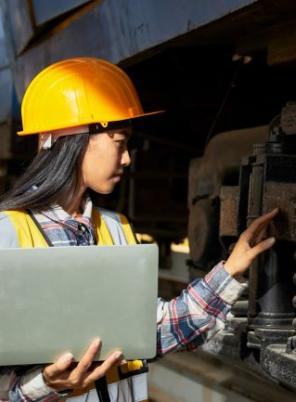 Woman with laptop studying train componentry